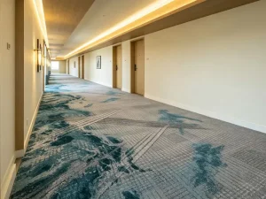 Abstract teal ocean wave design contract carpeting for luxury hotel corridors.