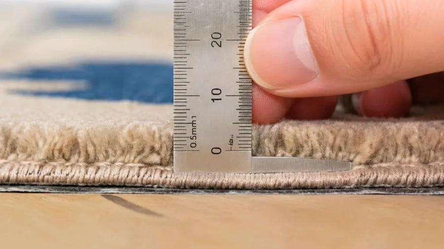 Carpet pile height measurement with calipers on commercial wool carpet