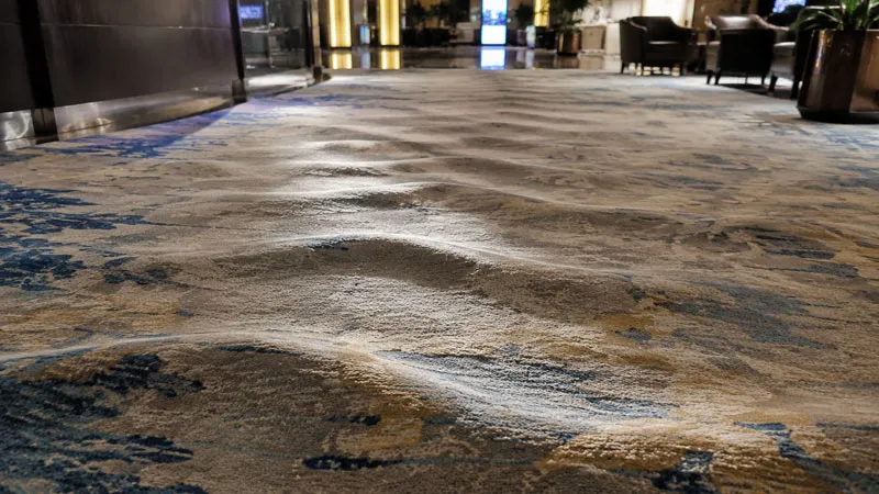 wavy carpet buckling in hotel lobby commercial installation